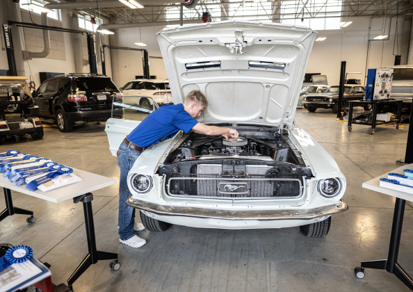 Georgetown High automotive technology student Evan Carson makes engine adjustments to a 1967 Ford Mustang during  the Georgetown ISD State of the District gathering held at the Future Ready Complex on Friday, March 6, 2026.