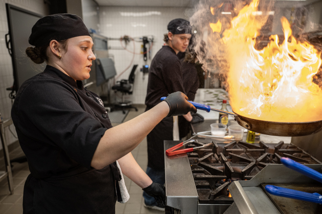 Senior Riley Kinser, an East View High School culinary arts student, keeps a close eye on Asian Green Beans she and her fellow students were preparing for attendees at the Georgetown ISD State of the District gathering held at the Future Ready Complex on Friday, March 6, 2026.  District students and staff were on hand to demonstrate their skills in various areas.  Superintendent Dr. Devin Padavil, joined by several GISD students, also gave a talk near the end of the program. Photo by Andy Sharp. 