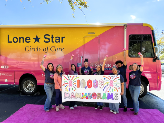The Big Pink Bus team, from left to right: Alaina Weaver, Penny Howard, Ginza Lopez, Wendy Cordero, Domenica Cambron, Elida Gomez, Roberto Hernandez and Rebecca Sorensen celebrate The Big Pink Bus performing 10,000 mammograms for women in Central Texas. Photo courtesy of Lone Star Circle of Care.
