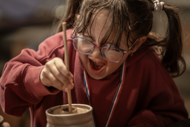 6-year-old Joanna Taylor enjoyed learning how to churn butter at the Old Settlers Association  site during The Williamson Museum’s Hoppy Easter event on Saturday, March 14, 2026.