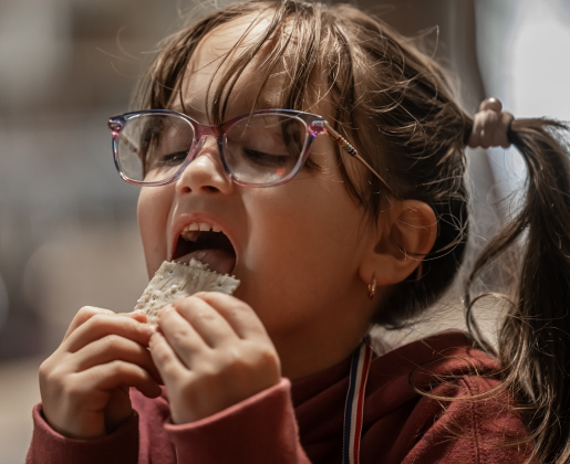 6-year-old Joanna Taylor samples some of the homemade butter she helped churn  at the Old Settlers Association  site during The Williamson Museum’s Hoppy Easter event on Saturday, March 14, 2026.    Photo by  Andy Sharp.