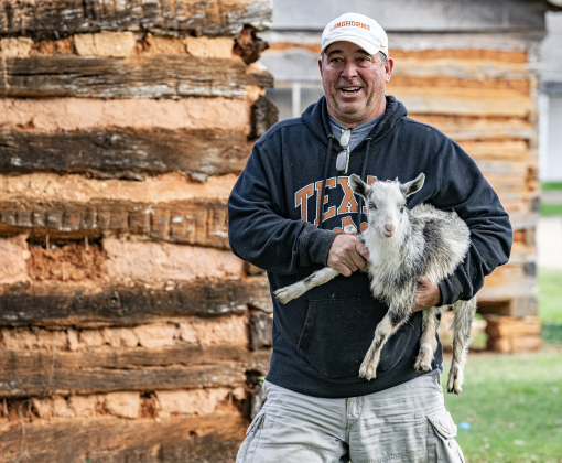 Randy Michna totes a Nigerian Pygmy Goat to  the petting zoo area at the Old Settlers Association  site during The Williamson Museum’s Hoppy Easter event on Saturday, March 14, 2026.    Photo by  Andy Sharp.