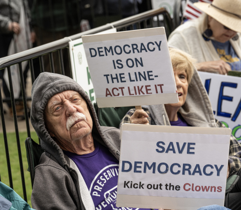 John Luther, left, was joined by his wife Sunny, right, at the No Kings rally held in downtown Georgetown on Saturday, March 28, 2026.  Approximately 700 people attended the rally, a demonstration opposed to the current Presidential administration of Donald Trump.  Photo by  Andy Sharp.