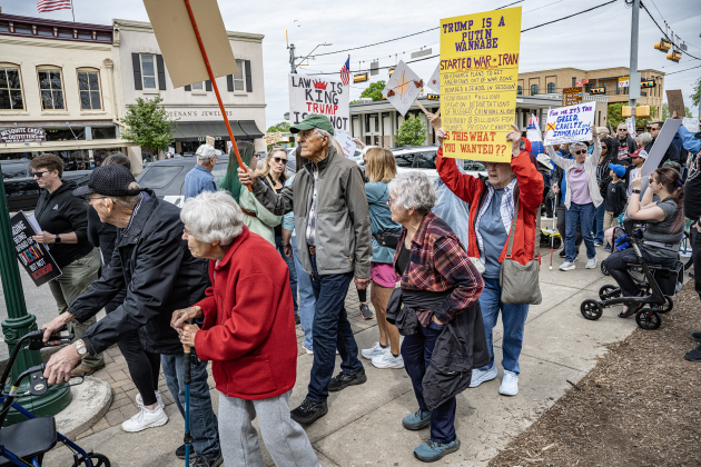 Attendees walk along Austin Avenue at the No Kings rally held in downtown Georgetown on Saturday, March 28, 2026.