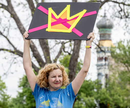 Whitney Dwire holds up her No Kings poster  during the No Kings rally held in downtown Georgetown on Saturday, March 28, 2026.  Approximately 700 people attended the rally, a demonstration opposed to the current Presidential administration of Donald Trump.  Photo by  Andy Sharp.