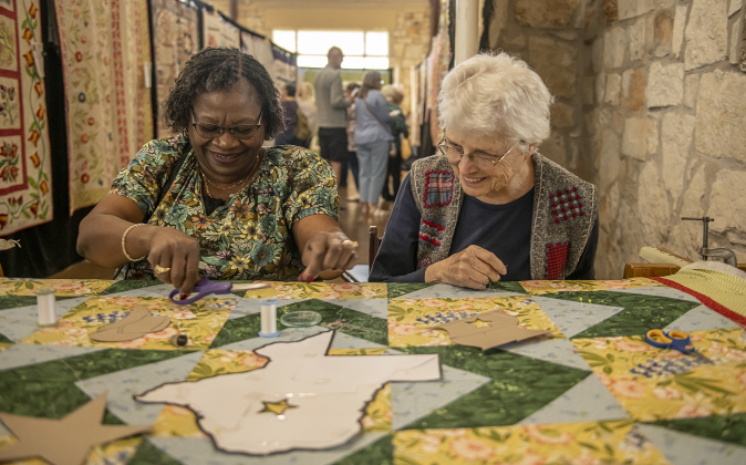 Doreen Ransaw, left, a  quilter from Harker Heights, paused from looking at quilts on display to join Sharon Frazier, right, as they worked on a quilt in progress  on Saturday, March 25, 2023 at the annual Georgetown Quilt Show, presented by Handcrafts Unlimited.