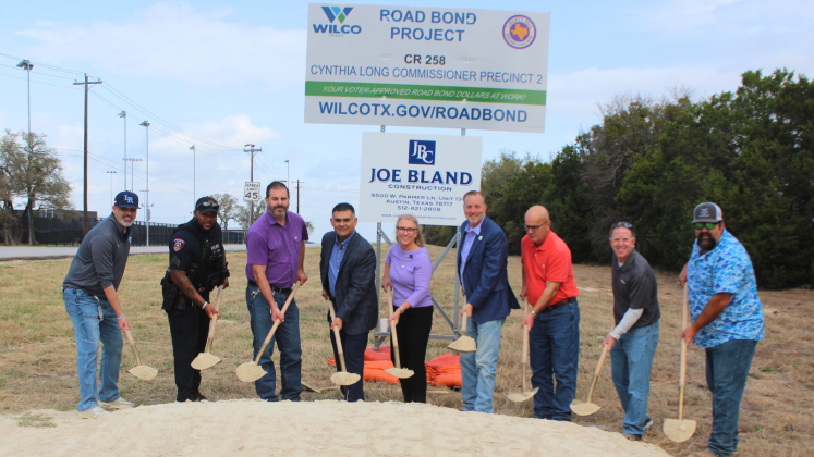 Breaking ground for the Legacy Ranch Drive project, from left, are Mark Koller, Legacy Ranch High School principal; John Gardner, Liberty Hill ISD Police Department; Dustin Akin, Liberty Hill ISD executive director of operations; Alex Salazar, Liberty Hill ISD deputy superintendent; Commissioner Cynthia Long, Precinct 2; County Judge Steve Snell; Kyle Klussmann, Joe Bland Construction; Chase Myers, American Structurepoint; and Steven Shull, HNTB. (Photo courtesy Williamson County) 