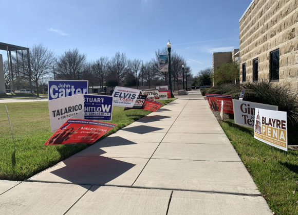 Campaign signs line the sidewalk leading to Georgetown City Hall. 