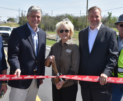 From left, Georgetown City Manager David Morgan, Precinct 3 County Commissioner Valerie Covey and County Judge Steve Snell cut the ribbon connecting Southwestern Boulevard to SE Inner Loop. (Photo by Kaitlyn Wilkes)
