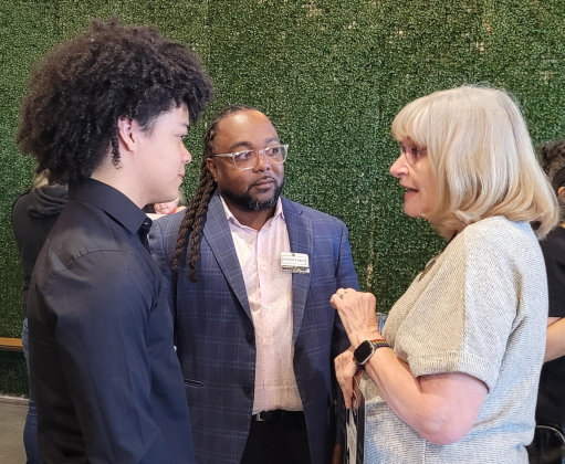 Matthias Early, left, is joined by his father, Justin Early, center, who is running for Congressional District 31, and Democratic Party Chair Kim Gilby have a conversation after the campaign kick-off. Photo by Nalani Nuylan.