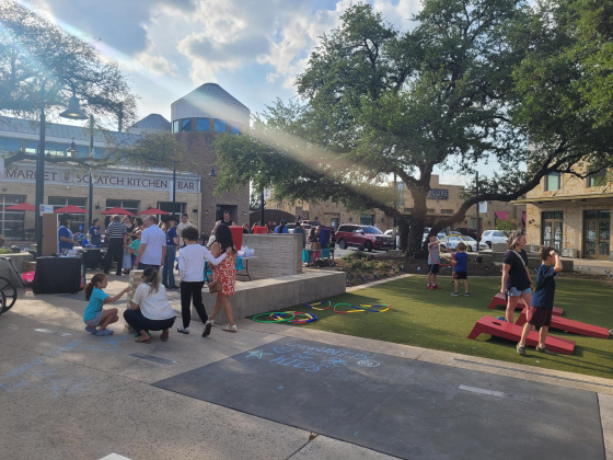 Families from Wilco attend the CAC’s first Party on the Plaza kick-off at the Rivery in Georgetown. Attendees play games, eat food and even got messages at the event. Photo by Nalani Nuylan.
