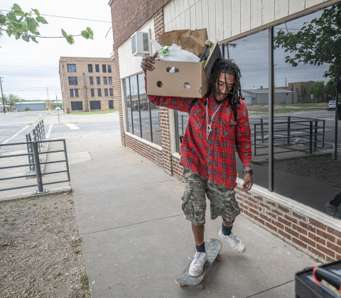 Jeremiah Thomas navigates his skateboard after receiving food from Shepherd’s Heart Food Pantry on Saturday, March 28, 2026.  Shepherd’s Heart Food Pantry and Thrift Shop, at 121 East 2nd Street, was founded by Executive Director Loretta Masters in 1994.  The group distributes food several times a week.  In 2025 Shepherd’s Heart averaged 2,110 distributions a month.    Photo by  Andy Sharp.