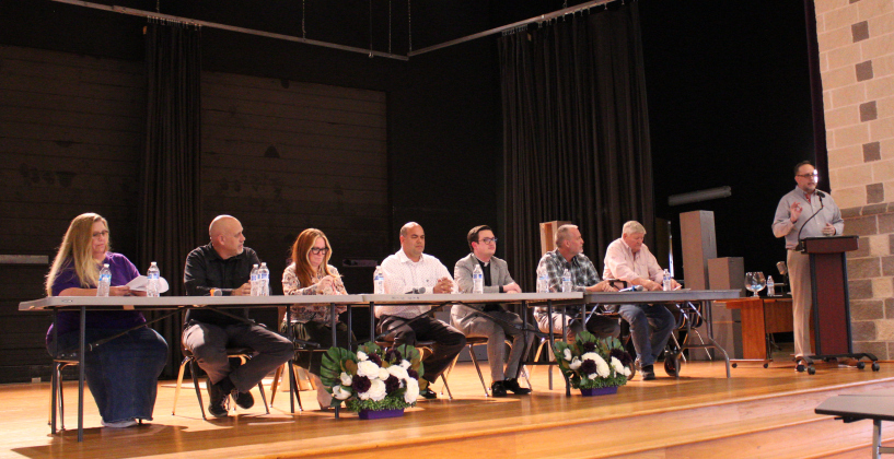 From left, Renee Morgan, Forrest Hyde, Ashley Gilland, Jose Perez, Brett Banks, Ben Daniel and David Merideth participate in a candidate forum hosted by the Florence Chamber of Commerce in the Florence High School Cafeteria on April 16. The form was moderated by Justin Gibson, standing. Photo by Nalani Nuylan.