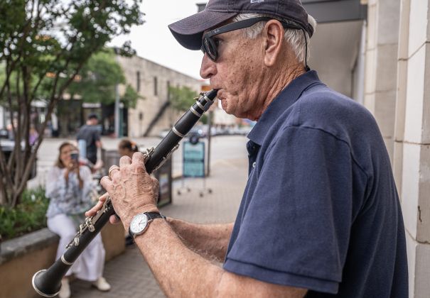 Clarinetist Don Denzin, a member of Swing Shift, performs along Austin Avenue near the Williamson Museum.