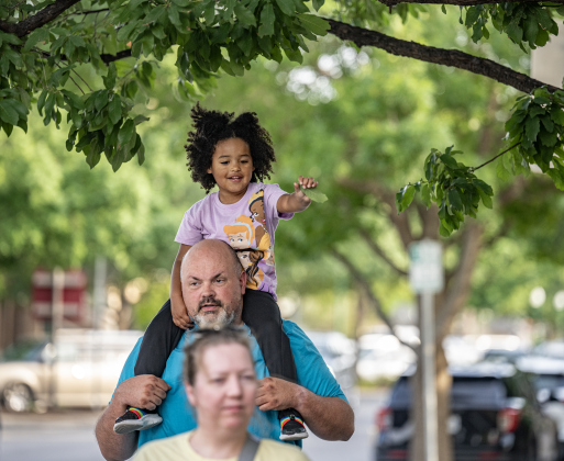 Three-and-a-half year-old Genesis Hero and her dad Sam Hero walk  along Main Street.