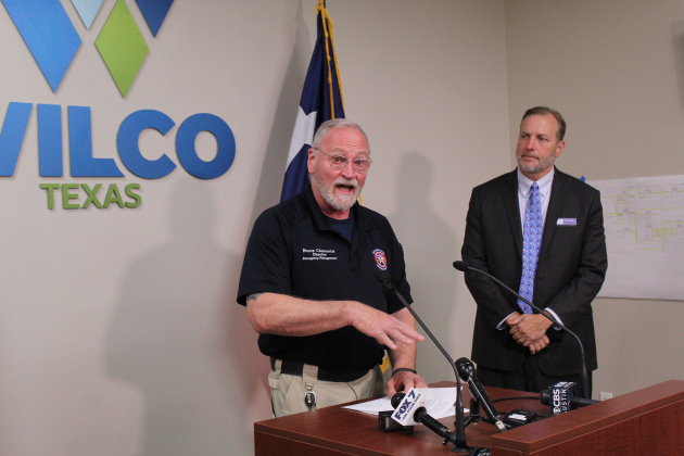 Williamson County Emergency Management Director Bruce Clements (left) provides an update during a press conference on April 21 about a Flash Flood Warning, triggered by continuous rain over the past few days. County Judge Steve Snell (right) listens in. Photo by Nalani Nuylan.