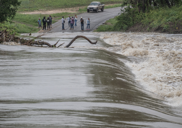 County Road 100 at Mankin’s Crossing was impassable as the San Gabriel River covered the bridge at approximately 6:30pm on Tuesday, April 21, 2026. Rain was present throughout the day in Williamson County, closing some of the area’s roads.      Photo by  Andy Sharp.