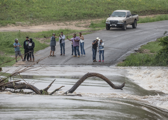 County Road 100 at Mankin’s Crossing was impassable as the San Gabriel River covered the bridge at approximately 6:30pm on Tuesday, April 21, 2026. Rain was present throughout the day in Williamson County, closing some of the area’s roads.      Photo by  Andy Sharp.