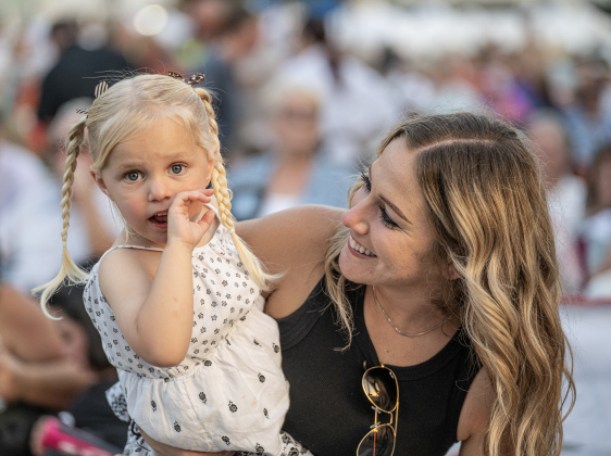 Melissa Yoho and her daughter Paisley, 3, enjoy a performance by Dysfunction Junction on Friday, April 24, 2026.