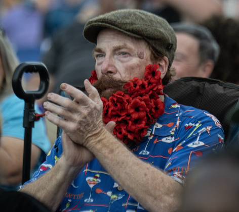 Steve Stratton, wearing a red poppy beard, was among the attendees along Austin Avenue on Friday, April 24, 2026.