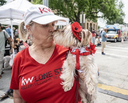 Zoe, a Yorkie, gives a kiss to her loving  human, Julie Jones, who participated in the Red Poppy Festival POPP Pup Parade and costume contest on Sunday, April 26, 2026.
