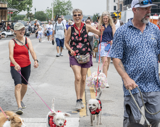 Susan Blackledge, center,  walking along Austin Avenue, took part in  in the Red Poppy Festival POPP Pup Parade and costume contest on Sunday, April 26, 2026.   Photo by  Andy Sharp.