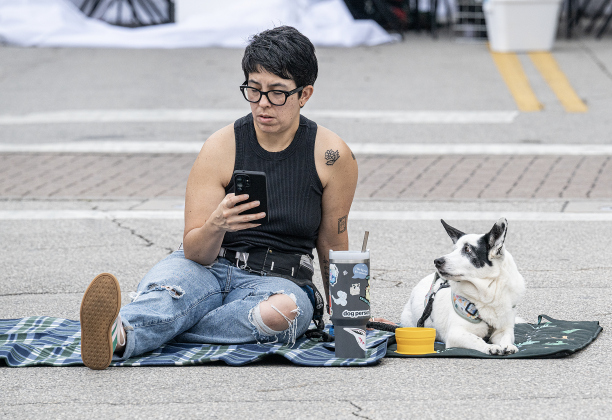 Mequela Lucero waits with Bruce Wayne, her Cowboy Corgi, for the start of the Red Poppy Festival parade on Saturday, April 25, 2026.   Photo by  Andy Sharp.