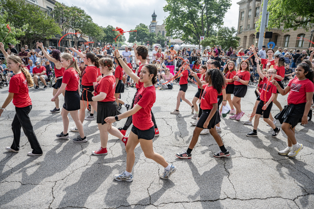 Students from the Georgetown Palace education program stroll together along Austin Avenue during the Red Poppy Festival parade on Saturday, April 25, 2026.   Photo by  Andy Sharp.
