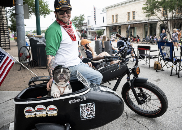 Jeff Lanfear and his French Bulldog named Willow wait for the start of the Red Poppy Festival parade on Saturday, April 25, 2026.   Photo by  Andy Sharp.