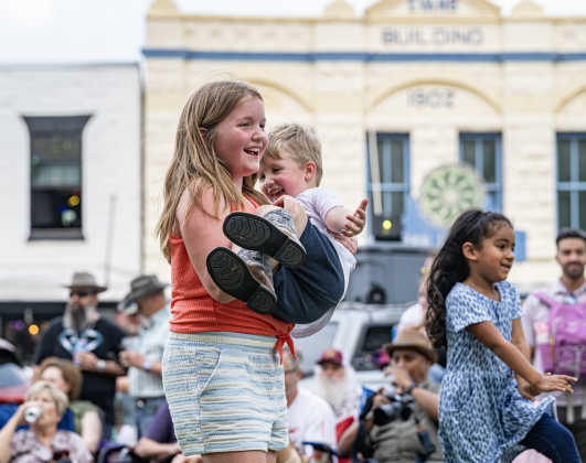 Mary Williams, 9, enjoyed a dance with 4-year-old Holton Henton  as they listened to  the music of Supernatural ATX, a Santana Tribute Band, during the first First Friday free concert of the year on the courthouse lawn on Friday, April 3, 2026.  The event was hosted by the Georgetown Beard Club.   Photo by  Andy Sharp.