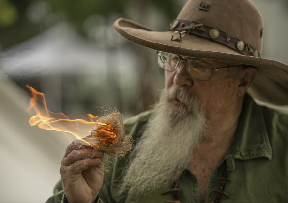 Mark Lynd makes fire using flint and steel during the 18th Annual Pioneer Days, held Saturday, May 4, 2024 at the Old Settlers Association site in Round Rock.  The event is hosted by the Williamson Museum.    Photo by Andy Sharp. 