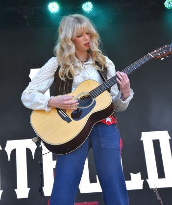 Eleanor Balcom, from The Castellows, plays guitar during her and her sisters set on April 19 on the Showdeo stage. The trio of singers are from Georgetown, Georgia, and are headlining a tour this fall.