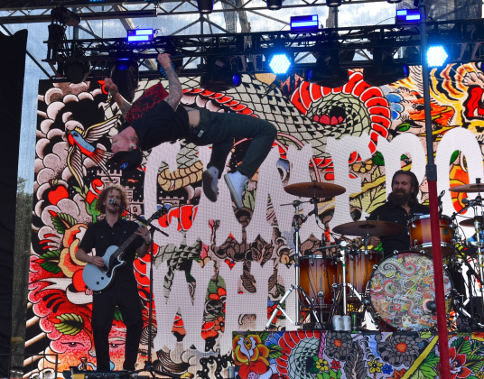 Cameron Whitcomb does a backflip on stage during his set on Sunday, April 19. The Canadian-born artist also competed on season 20 of singing-competition show American Idol.