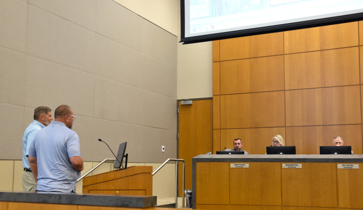 Trae Sutton, Vice President and COO of KPA Engineers, far left, and Lua Saluone, left, Transportation Manager, present the schematics for Austin Avenue and University Avenue to city council during the April 28 meeting. (Photo by Kaitlyn Wilkes)
