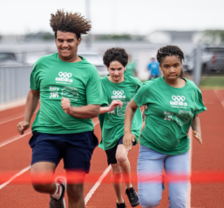 East View High student Juanlys Tejeda, left, Antonio Guilfu, center, also from East View High, and Karmen Ellis, right, from Forbes Middle School, race to the finish line in a 100-meter race during  the Georgetown ISD Special Olympics on Tuesday, May 5, 2026.