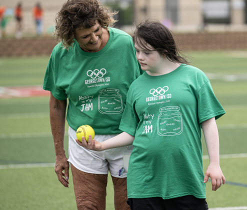 East View student Caitlyn Clawson gets guidance and encouragement from East View paraprofessional Paula Dieckman as she participates in the softball throw during the Georgetown ISD Special Olympics on Tuesday, May 5, 2026.