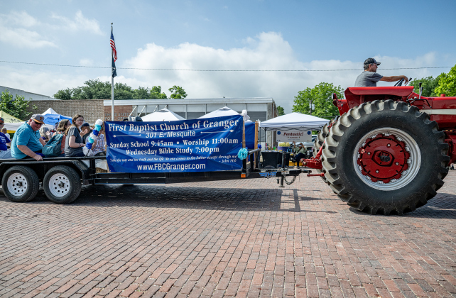 Members of  First Baptist Church of Granger ride in a parade  float pulled by a tractor along West Davilla Street during the 47th Annual Granger Lakefest on Saturday, May 9, 2026.   Photo by Andy Sharp.