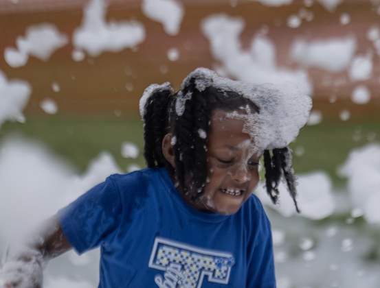 5-year-old Raelynn Ford had fun in the bubbles at  the Foam Party during the 47th Annual Lakefest in downtown Granger on Friday, May 8, 2026.    Photo by Andy Sharp.