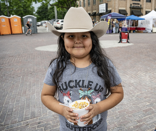 7-year-old Evelyn Alvarez had fun with her family as she enjoyed a treat along West Davila Street during the 47th Annual Lakefest in downtown Granger on Friday, May 8, 2026.    Photo by Andy Sharp.
