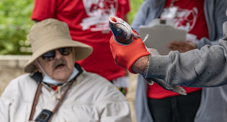 Larry Newell, who caught over 25 fish, admires one of his catches held by a staff member  during the 23rd Annual SPJST Senior Living Fishing  Tournament on Thursday, May 7, 2026. Senior Living residents fished for 600 pounds of Channel Catfish during the two-day event which continued on Friday.  Residents and staff were treated to a fish fry to celebrate the event.  The fish were provided by Larry’s Fish Farm in Giddings.   Photo by Andy Sharp.