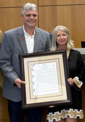 Assistant City Manager Laurie Brewer receives a framed certificate from City manager David Morgan. She is retiring this month after 33 years with the city.   Photos courtesy the City of Georgetown