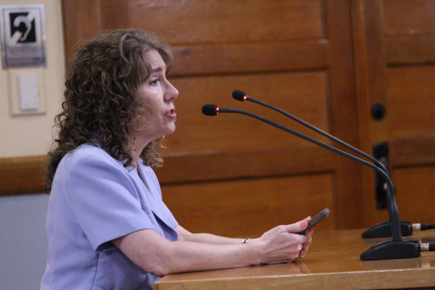 Stephanie Tibbets, vice president for the Saddle Creek Board of Directors for the HOA and a retired pediatric sexual assault nurse examiner, speaks against the proposed Justice Complex location during the May 12 Commissioners Court meeting. Photo by Nalani Nuylan.