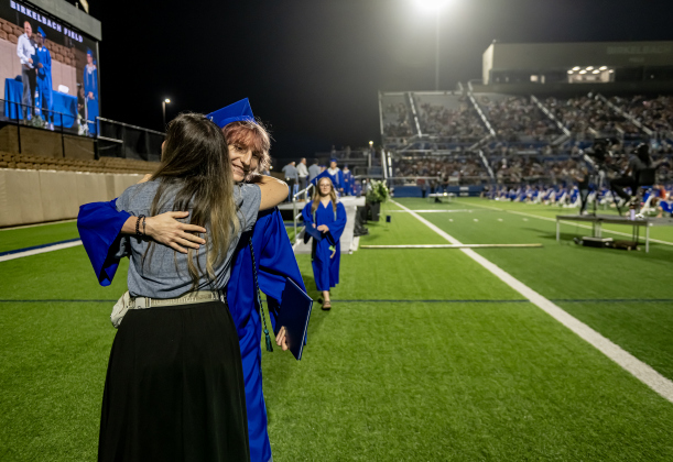 Assistant Principal Melanie Tunnell hugs Cameron Wallace after he receives his diploma during the 2026 Georgetown High School commencement, held Friday, May 22, 2026 at Birkelbach Stadium.  484 students received their diplomas on this evening.     Photo by Andy Sharp.