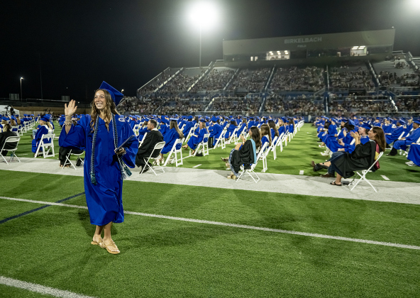 Diane Holzschull takes photos of graduate Elijah Alvarado during the 2026 Georgetown High School commencement, held Friday, May 22, 2026 at Birkelbach Stadium.  484 students received their diplomas on this evening.     Photo by Andy Sharp.
