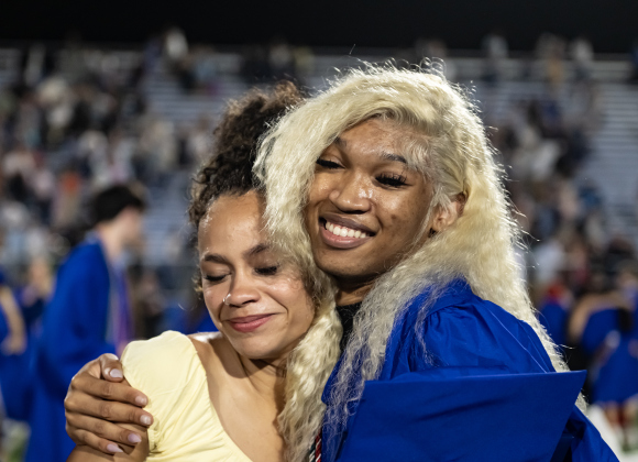 Graduate Reginald Hull, Jr. gets a hug from Kierra Mosee, left, after  the 2026 Georgetown High School commencement, held Friday, May 22, 2026 at Birkelbach Stadium.  484 students received their diplomas on this evening.     Photo by Andy Sharp.