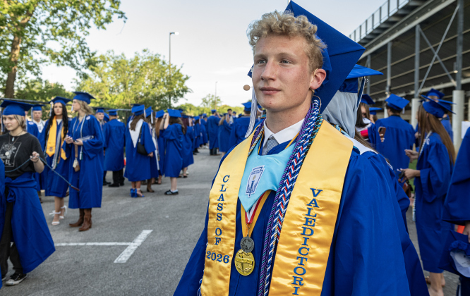 Georgetown High School Valedictorian John Papaconstantinou waits to enter the field with his classmates during the 2026 Georgetown High School commencement, held Friday, May 22, 2026 at Birkelbach Stadium.  484 students received their diplomas on this evening.     Photo by Andy Sharp.