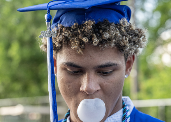 Nick Hanson relaxes while making large bubbles with his bubble gum  prior to going onto the field with his classmates during the 2026 Georgetown High School commencement, held Friday, May 22, 2026 at Birkelbach Stadium.