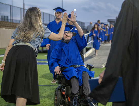 Christopher Cain is congratulated by Assistant Principal Melanie Tunnell after receiving his diploma during the 2026 Georgetown High School commencement, held Friday, May 22, 2026 at Birkelbach Stadium.  484 students received their diplomas on this evening.     Photo by Andy Sharp.