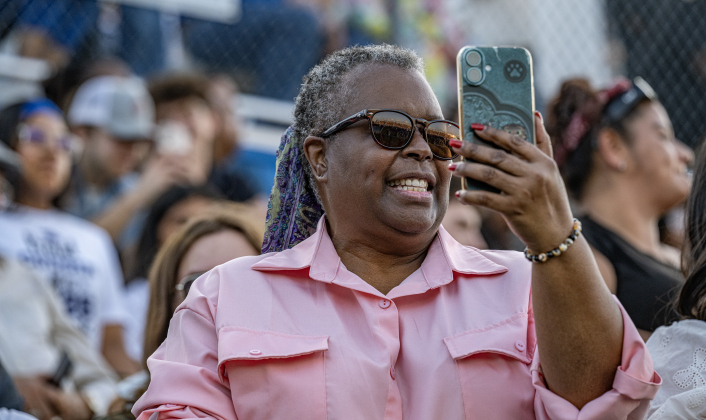 Diane Holzschull takes photos of graduate Elijah Alvarado during the 2026 Georgetown High School commencement, held Friday, May 22, 2026 at Birkelbach Stadium.  484 students received their diplomas on this evening.     Photo by Andy Sharp.