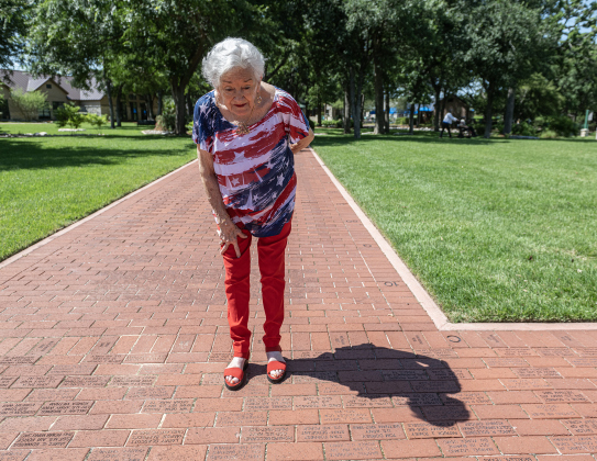 Betty Gresham looks for the commemorative brick honoring her late husband Don Gresham in the Williamson County Veterans Memorial Plaza after the official   Memorial Day ceremony concluded Sun City on Monday, May 25, 2026. Photo by Andy Sharp.